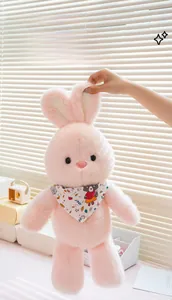 Detailed close-up of a soft pink plush rabbit toy with a cute printed neckerchief