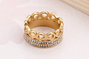 Macro shot of gold infinity ring featuring double row paved crystals on titanium steel