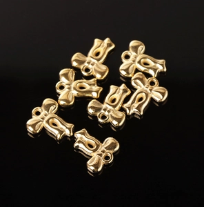 Macro shot of seven gold bow-knot pendants with hanging rings on black background