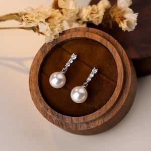 French style S925 silver earrings with sparkling zircon and white pearls on wooden box