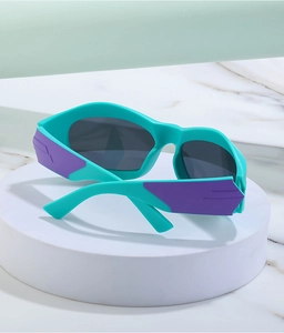 Detailed close-up of mint green Y2K sunglasses with purple accents and dark gray lenses