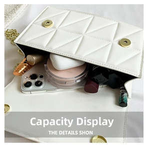 Interior view of white quilted chain bag showing capacity for phone and cosmetics