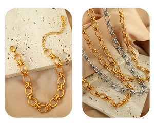 Detail of luxury gold and silver titanium steel bracelets with oval link chain design