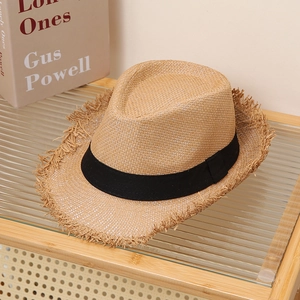 Detail of frayed edge khaki straw fedora with black decorative ribbon on display