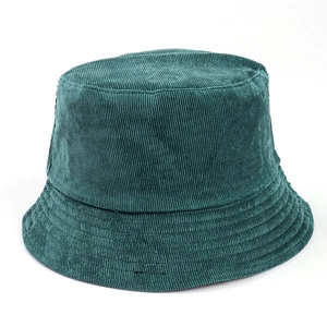 Detailed close-up of dark green corduroy bucket hat with reinforced stitching on brim