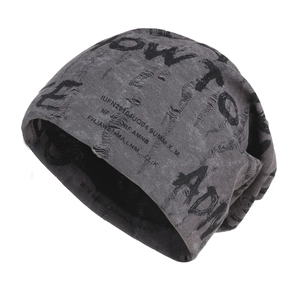 Detail of distressed grey knitted beanie featuring punk style ripped textures and text