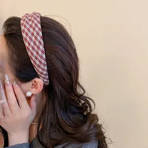 Red and white checkered fabric headband shown on model with pearls in a retro chic style