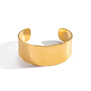 Minimalist wide cuff bracelet in 18K gold finish with vertical textured pattern