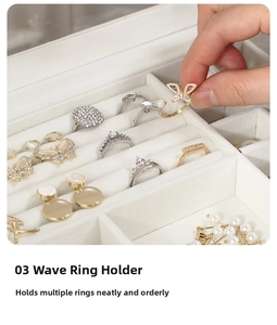 Detail of cream velvet jewelry box featuring wavy slots for organized ring storage