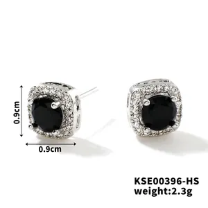 Macro shot of square zircon stud earrings with black center stone and silver plating