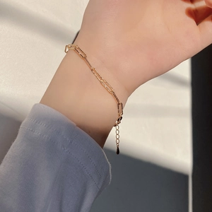 Elegant 925 sterling silver golden paperclip link bracelet on woman wrist with adjustable chain