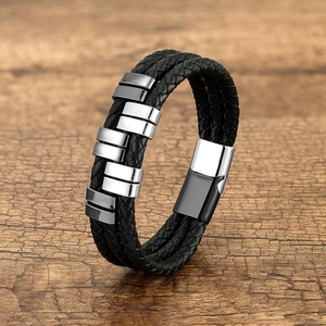 Detail view of multi-layer black braided leather bracelet with silver magnetic metal clasp