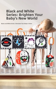 Detail of black and white high-contrast baby sensory fabric book and hanging soft toys