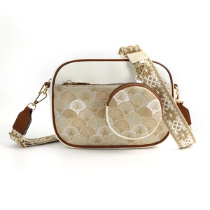 Detail of quilted jacquard fabric with champagne gold fan pattern and small round coin purse