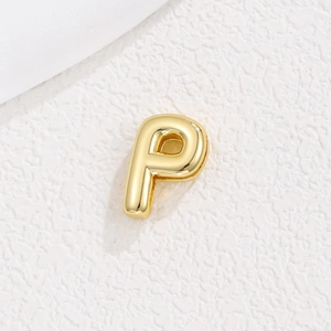 Detailed view of a 10mm gold plated alphabet P charm bead for DIY metal bracelets