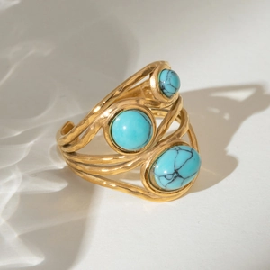 Vintage gold layered open ring with three turquoise stones and hammered metal textures