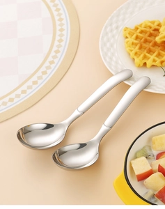 Polished stainless steel round spoons set shown in a cozy home dining dessert scene