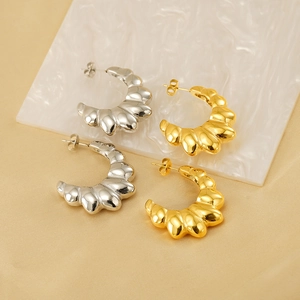 Vintage croissant shell hoop earrings in 18K gold and silver finishes on silk fabric