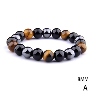 Macro detail of 8mm tiger eye, obsidian and hematite beads on a stretch bracelet
