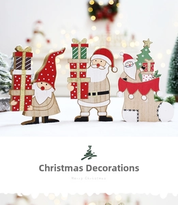 Detailed close-up of three handcrafted wooden Christmas figurines with glitter finish