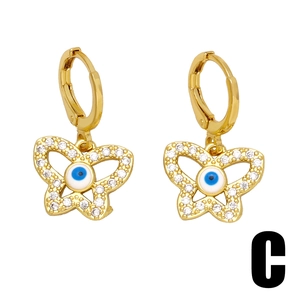 Golden butterfly hoop earrings with sparkling rhinestones and Evil Eye center detail
