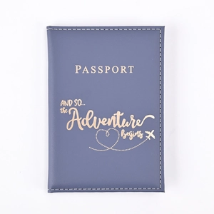 Detail of navy blue PU leather passport holder with golden adventure quote and heart plane