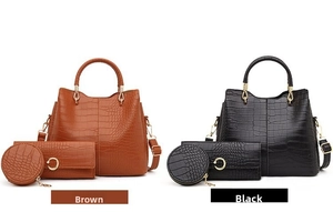 Detail view of brown and black crocodile embossed tote bags with matching wallets
