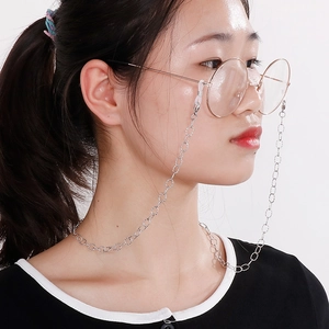 Silver stainless steel eyeglass chain with O-chain design worn by a female model