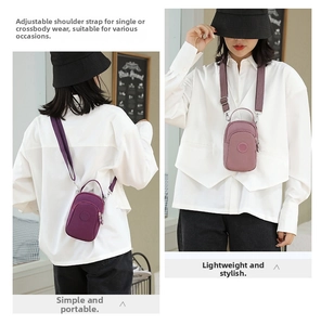 Detailed view of mini nylon crossbody bag with adjustable wide strap and multi-zipper pockets