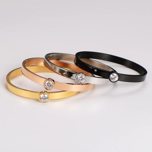 Sleek stainless steel bangles set in gold, rose gold, silver, and black with single crystal