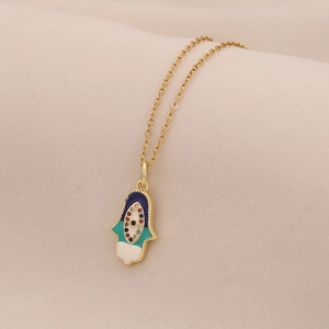 Macro detail of Hamsa Hand necklace with colorful enamel and cubic zirconia stones