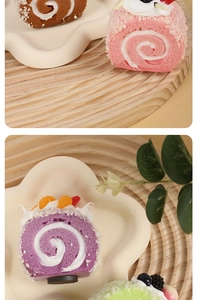 Detailed macro view of assorted artificial Swiss rolls with fruit toppings and cream decor