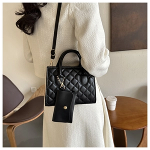Quilted black leather tote bag with matching coin purse and adjustable shoulder strap