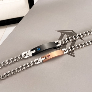 Detail of couple bracelets with zircon stone on black and rose gold stainless steel plates