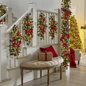 Christmas teardrop swag with lights, red berries, and pinecones for stair decoration