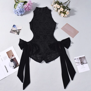 Flat lay of black lace bodysuit with large side bows and neck ribbon detail