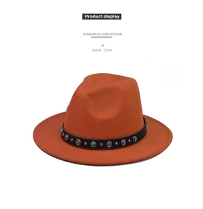 Close-up of orange wool fedora hat with sapphire chain and metallic stud details