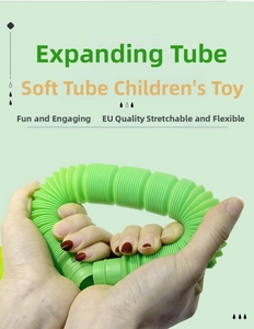Detail of green flexible pop tube toy being stretched and curved by hands