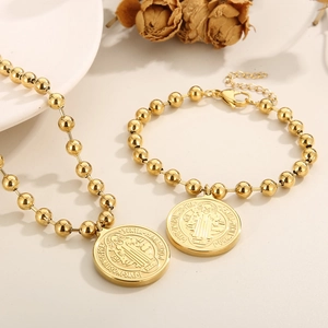 Vintage gold beaded jewelry set featuring engraved saint portrait necklace and bracelet