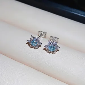 Minimalist S925 silver snowflake stud earrings with sky blue zircon on jewelry box