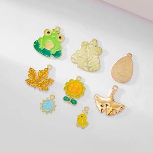 Set of 10 gold-plated enamel charms including frog, sunflower and ginkgo leaf pendants