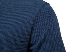 Close-up of navy blue waffle knit texture and seam detail on a high-quality cotton T-shirt