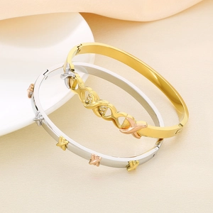 Two-tone gold and silver stainless steel open bangle with X design and sparkling zircon
