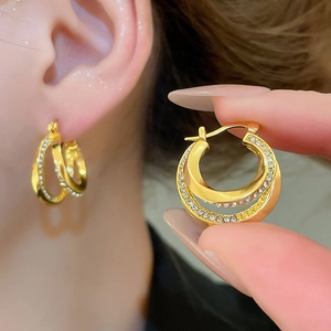 Close-up of double layered gold hoop earrings with sparkling pavé cubic zirconia