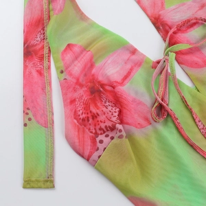 Detail of floral printed mesh fabric with gradient pink and green summer dress texture