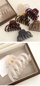 Close-up of large tortoiseshell hair claw clips in various colors with high grip detail