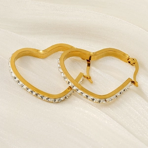 18k gold plated stainless steel heart hoop earrings with diamonds on white fabric