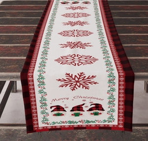 Close-up of Merry Christmas linen table runner with red snowflakes and gnome print