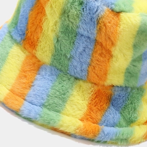 Close-up of rainbow striped plush bucket hat showing thick faux fur texture and vibrant colors