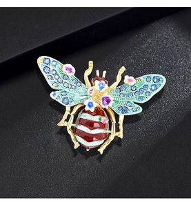 Detailed close-up of a vintage bee brooch with colorful enamel and sparkling rhinestones
